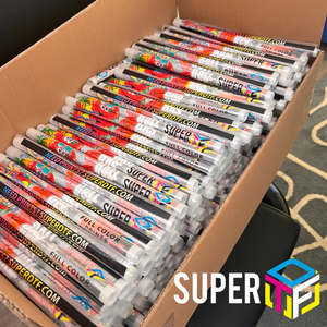 Box filled with Super DTF rolls on a carpeted floor