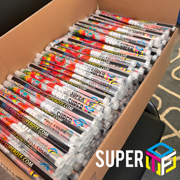 Box filled with Super DTF rolls on a carpeted floor