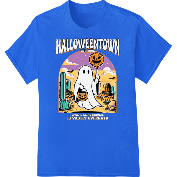 Cute ghost character with orange pumpkin hat, striped cape and smiling expression in front of purple haunted town backdrop