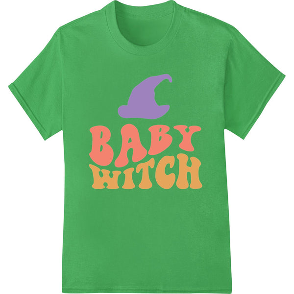 A digital heat transfer design featuring an adorable cartoon baby witch with green skin, pointy hat, and holding a magic...