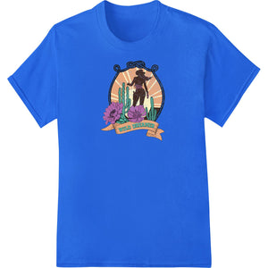 Heat transfer design of a cowgirl silhouette riding amidst saguaro cactus at sunset in the desert.