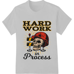 Black and white skull graphic with 'Hard Work in Process' text, representing dedication to hard work and perseverance.